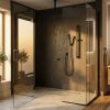 Modern bathroom with frameless glass shower, matte black fixtures, wood vanity and backlit mirror, sunlit frosted windows.